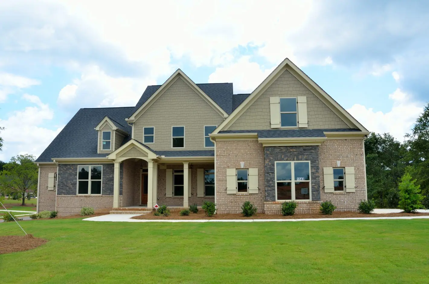 A large house with a lawn in front of it