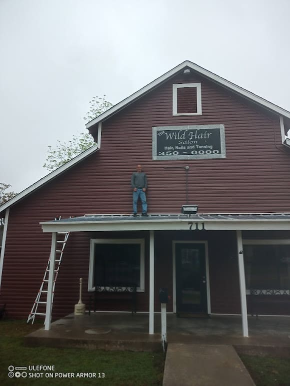 A man standing on the side of a building.